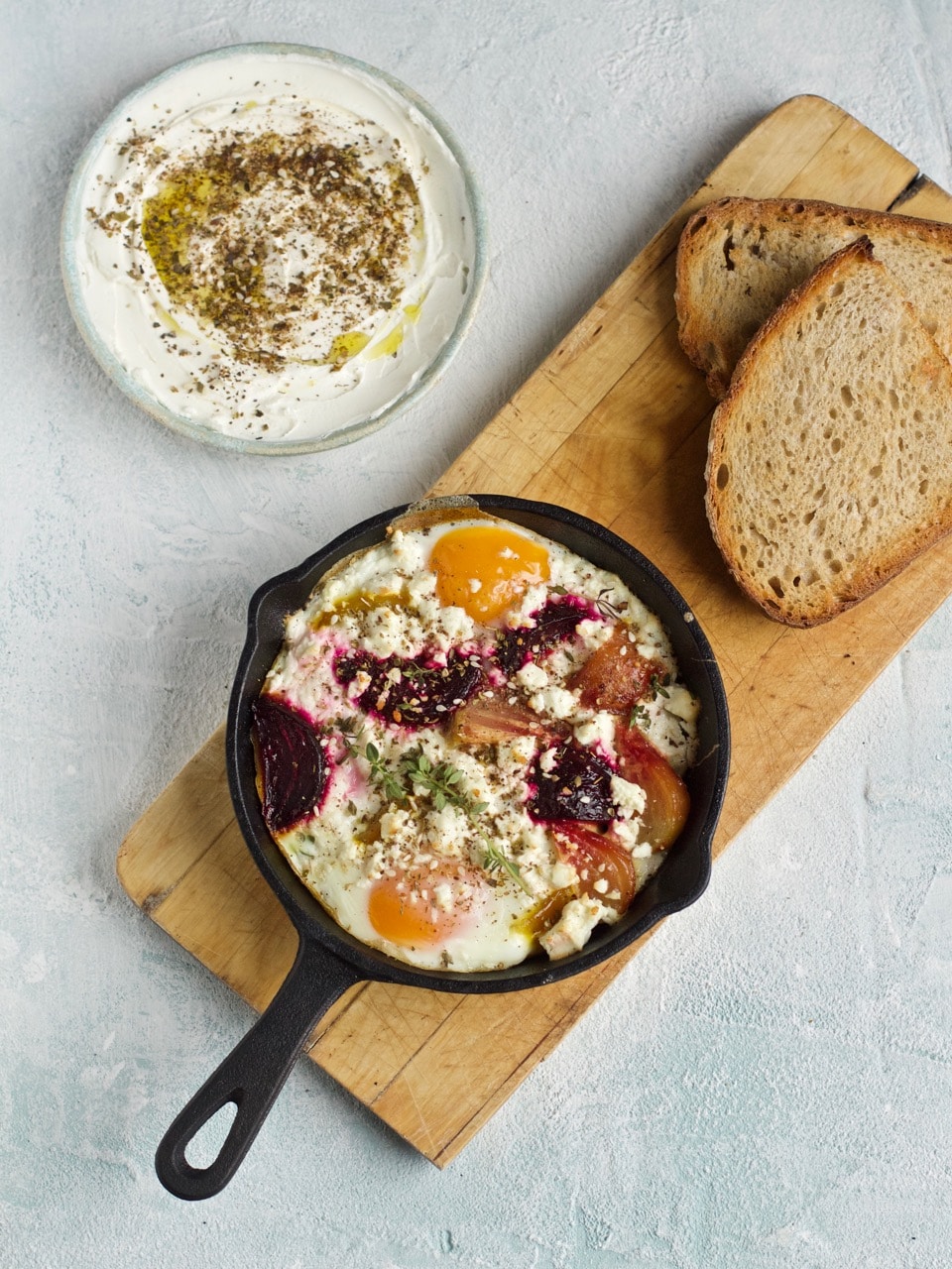 Individual cast iron pan baked eggs with beetroot, feta and thyme